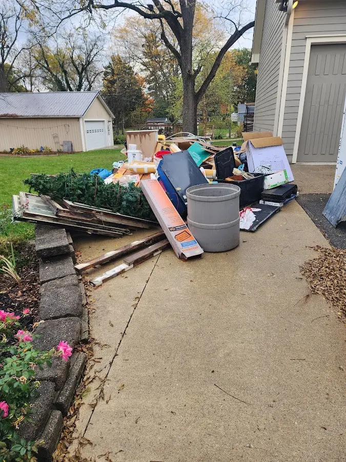 Dumpster being loaded with debris for 10 Yard Dumpster Rental in Essex